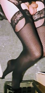 Penis Pump with Fishnet Bodystocking Over Black Stockings